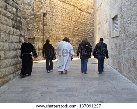 JERUSALEM - MARCH 28: A Religious man and dressed like Jesus Christ man walking on Mount Zion streets. March 28, 2013 in Jerusalem, Israel.