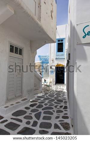 MYKONOS, GREECE- MAY 16: Mykonos street with external colourful stairs of the houses and art galleries, Mykonos, Greece, on May 16, 2013.