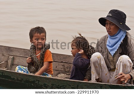Sap Lake, Cambodia - 29 March, 2011: Cambodian family sail on a boat near the fishing village of Tonle Sap Lake.
