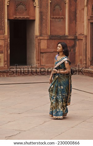 Varanasi, India, November 17, 2010: Beautiful Indian woman at Varanasi streets in the India with the typical traditional colored dress.