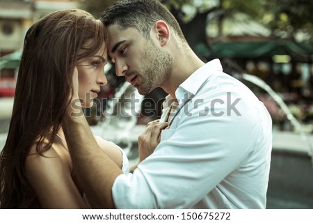 Young Couple Kissing Each Other On The Street