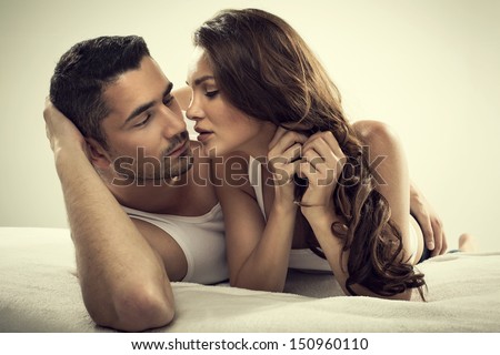 Handsome man and sexy woman in bed