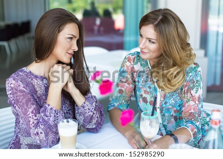 Two young women having coffee break