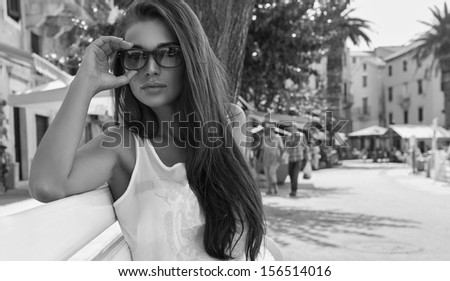 Black and white photo of attractive woman wearing sunglasses