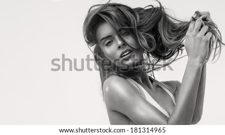 Fashion portrait of sensual woman with hair in hands