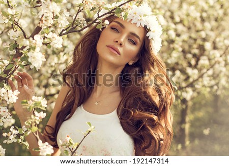 Beautiful natural woman in the garden of apple