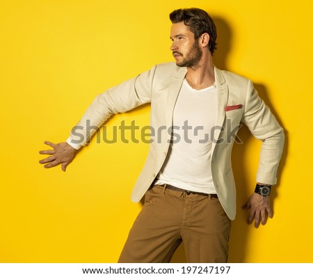 Handsome model on yellow background Handsome model on yellow background