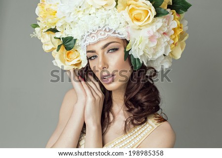 Glamour portrait of youg beautiful woman with flowers hair