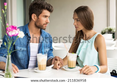 Two young people drinking frappe in restaurant