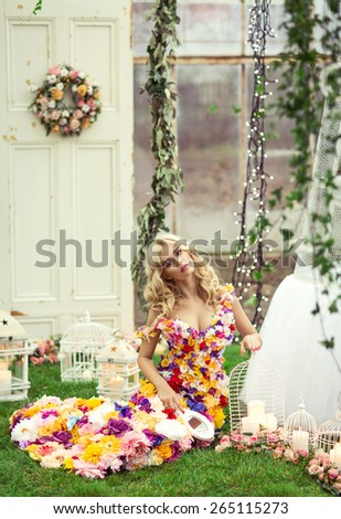 Beautiful blond woman in a dress of flowers