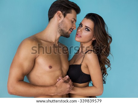 Fashion couple touching each other. Emotional portrait of unusual couple