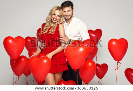 Valentine\'s photo of young loving couple with balloons heart
