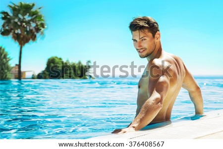 Portrait of handsome man in swimming pool