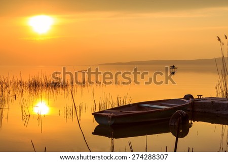 Sunset on the lake Balaton with a boat  in Hungary