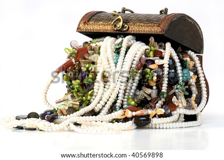 Chest full of jewelry treasures. Isolate on white