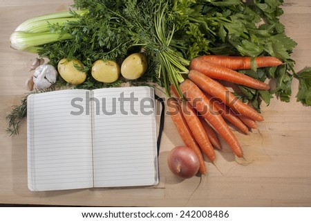 Recipe block note template on wooden cutting board with vegetables