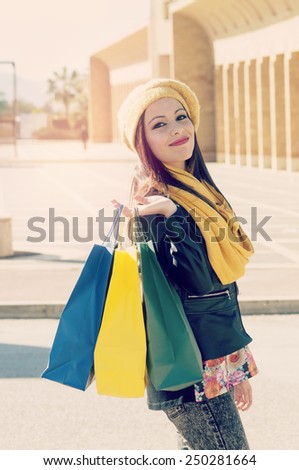 beautiful girl with shopping bag rejoices happy for purchases filter applied instagram style and a flare effect added