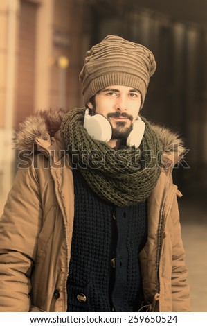 young man listens to music warm style toned