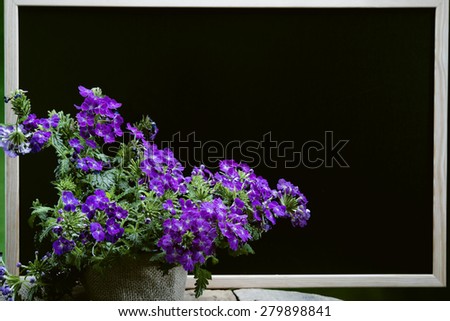 bouquet of  flowers in vase on blackboard background. with copypace