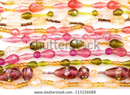 Strings of seed beads on a white background