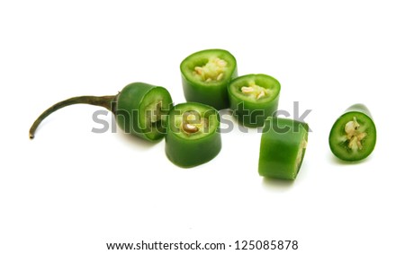 fresh green cut chili pepper pieces on a white background