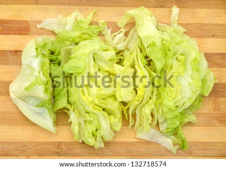 fresh iceberg salad isolated on wooden board