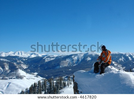 snowboarder looking over mountains
