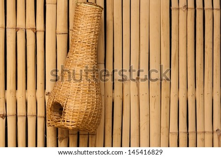 Bamboo eel trap norther Thai style hanging on bamboo wall