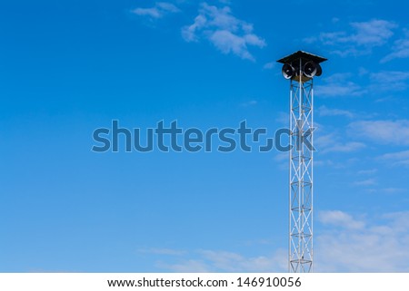 Speakers on the metal pole tower for announcement with blue sky background