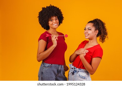 Afro Lesbian Couple On Yellow Background Stock Photo