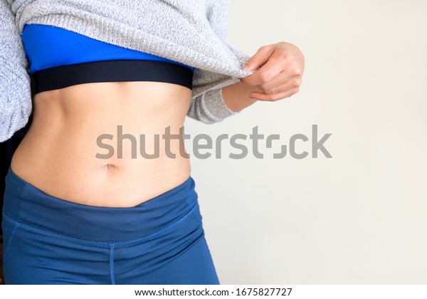 Aporty Woman Showing Belly Smooth Skin Stock Photo