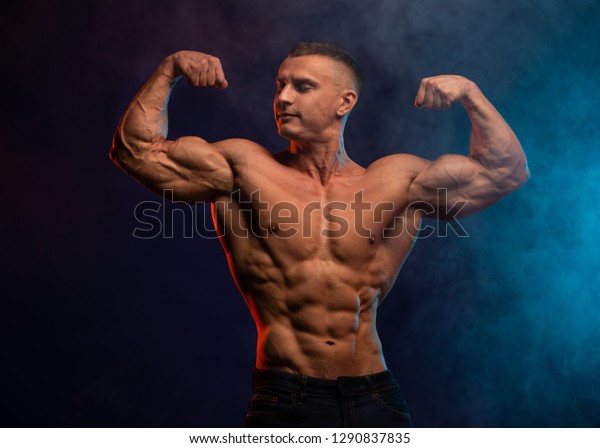 Athletic Shirtless Male Model Flexing Muscles Foto De Stock 1290837835