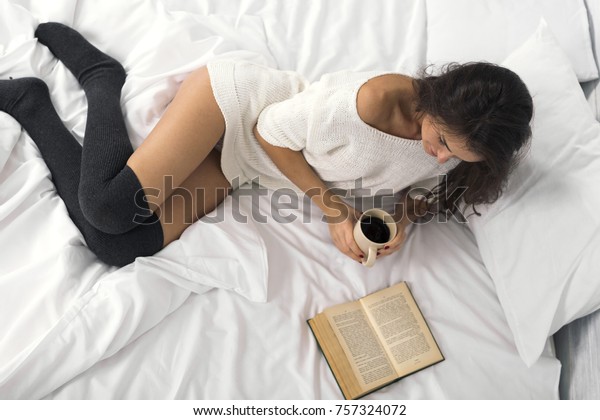 Attractive Brunette Woman Reading Book Holding