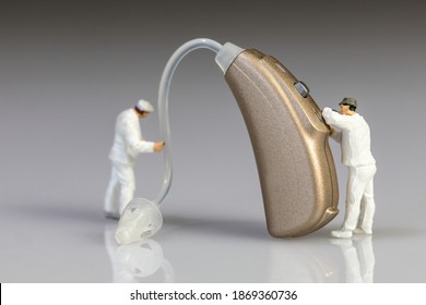 Audiologists Doing Hearing Aid Maintenance Stock Photo