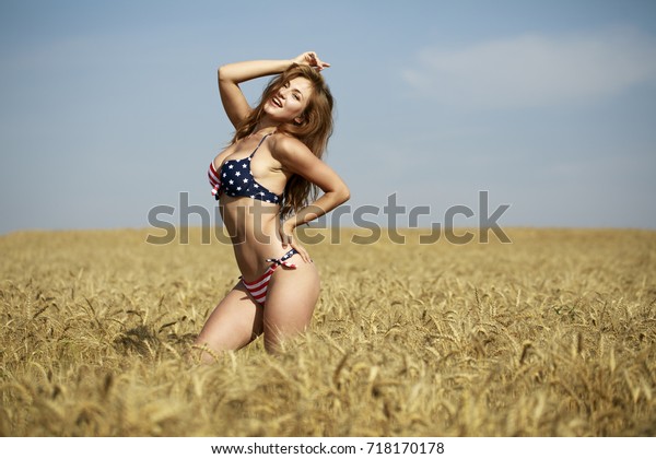 Back View Beautiful Blonde Woman In Sexy American Flag Bikini In A