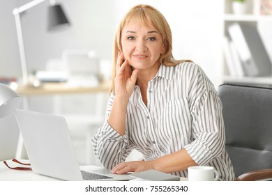 Beautiful Mature Woman Working On Laptop Stock Photo