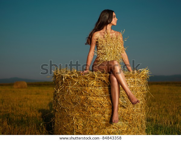 Beautiful Nude Woman Sitting On Hay Stack