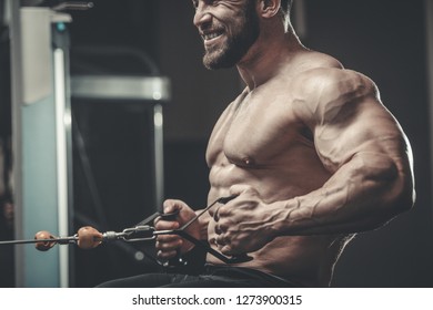 Brutal Strong Athletic Men Pumping Muscles Stock Photo