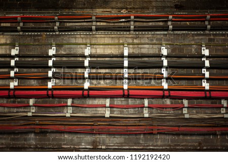 A bunch of live colorful wires at underground. The wires in Tube tunnels provide the communication and power supply functions