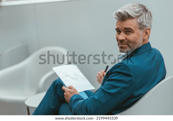 Busy Mature Businessman Workingon Documents While Stock Photo