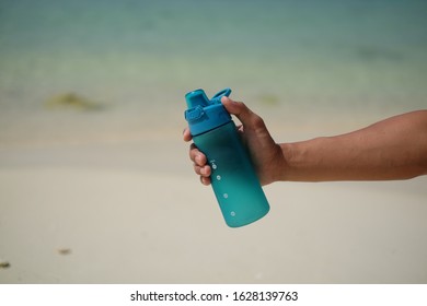 Close Hand Holding Reusable Water Bottle Stock Photo