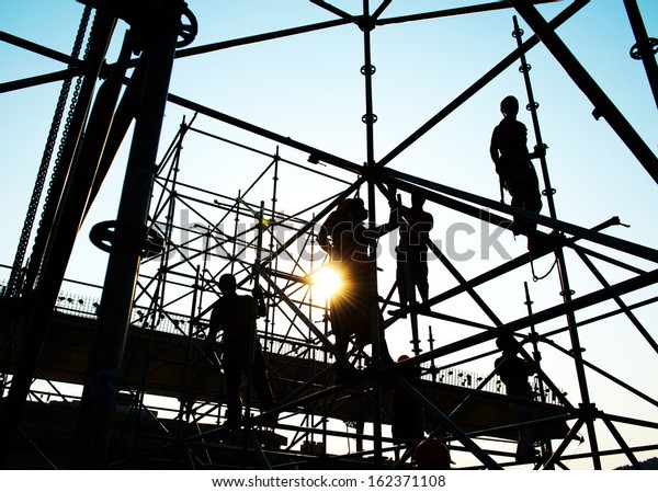 Construction Workers Working On Scaffolding Stock Photo Edit Now