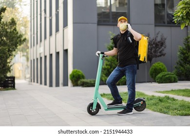 Delivery Man Yellow Uniform Stands Smartphone Stock Photo 2151944433