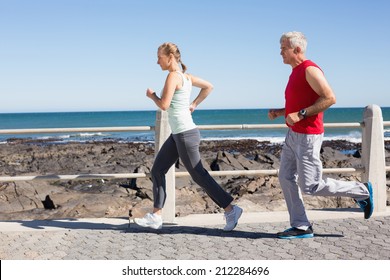 Fit Mature Couple Jogging Together On Stock Photo Edit Now 212284696