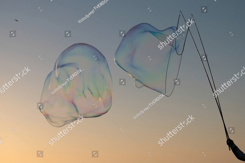 Giant Soap Bubble Flying Soap Bubbles On Sky Blue Background At Sunset