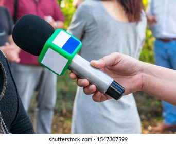 Hand Holding Microphone Conducting Business Interview Stock Photo