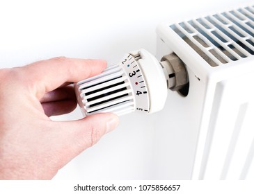 Hand Man Adjusting Temperature On Thermostat Stock Photo