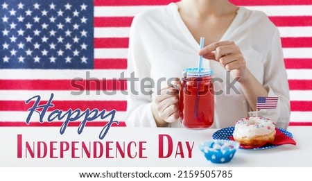 independence day, patriotism and holidays concept - close up of woman with iced donut drinking juice from mason jar glass or mug at 4th july party over flag of united states of america on background
