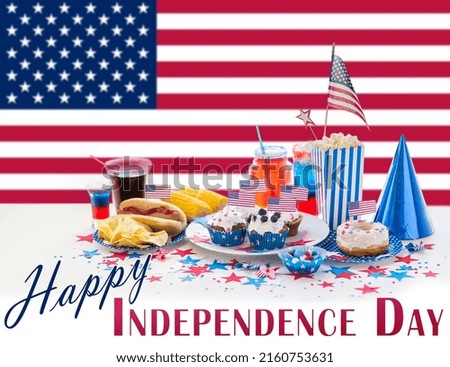 independence day, patriotism and holidays concept - close up of hot dog, potato chips and drinks at 4th july party over flag of united states of america on background