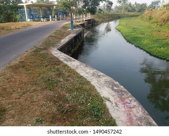 Irrigation Water Channel Through Rice Paddy Stock Photo